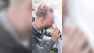 Inhaling big salami outdoors