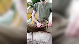 A sporty stud in a military uniform strokes off and ejaculates outdoors