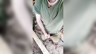 A sporty stud in a military uniform strokes off and ejaculates outdoors