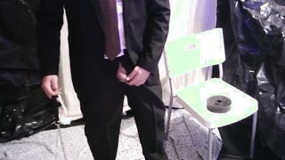 weights on the scrotum, pulling on them, in a suit and bind