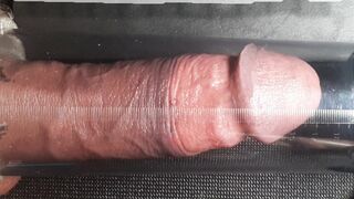 Close look of a Man attempting a manhood pump.