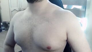 Muscled fellow plays with his puffies and muscles