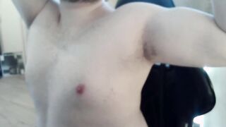 Muscled fellow plays with his puffies and muscles