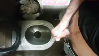 A thin unshaved man promptly strokes off in an airport restroom