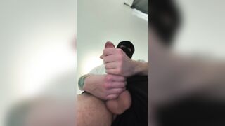 Beautiful dude in a mask is stroking and cuming on socks