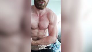 Beefy stud bodybuilder is showcasing his muscle and jack