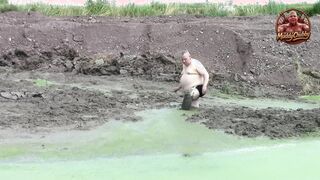 Mudbath in dark, cream-colored pond filth