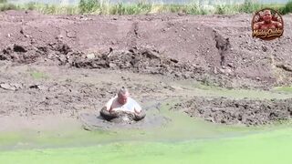 Mudbath in dark, cream-colored pond filth
