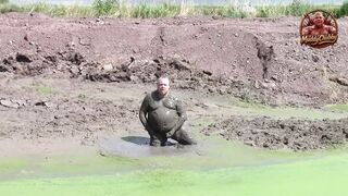 Mudbath in dark, cream-colored pond filth