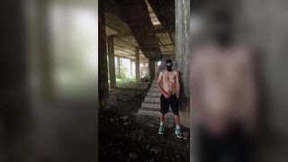 A unshaved, heterosexual chav fellow in a balaclava and stinky sneakers flashes his bone in a deserted palace