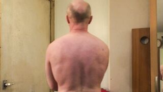 Beefy Dad bodybuilder ripples thick biceps dressed in a vest then disrobes, faps off and blows a load.