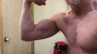 Beefy Dad bodybuilder ripples thick biceps dressed in a vest then disrobes, faps off and blows a load.