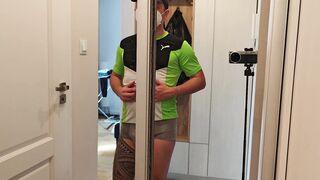 A hooded, thrilled boy displays off his muscles