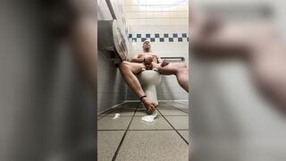 Jerking off in a public rest room while others come and go