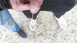 Buddy is holding my pecker while im pissing on the ground outdoor