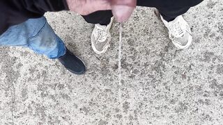 Buddy is holding my pecker while im pissing on the ground outdoor