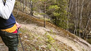 Furry kinky guy with a dick urinates in the spring woods right on camera