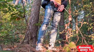 Fellow lengthy peeing in the woods under a tree