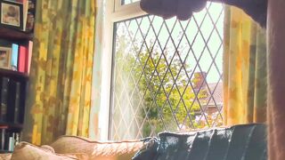 Having joy nude next to a window in utter glance with traffic passing by