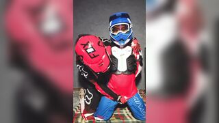 A dude in a motocross gear gets a dose on his mxhelmet