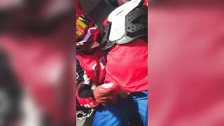 A dude in a motocross gear gets a dose on his mxhelmet