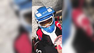 A dude in a motocross gear gets a dose on his mxhelmet